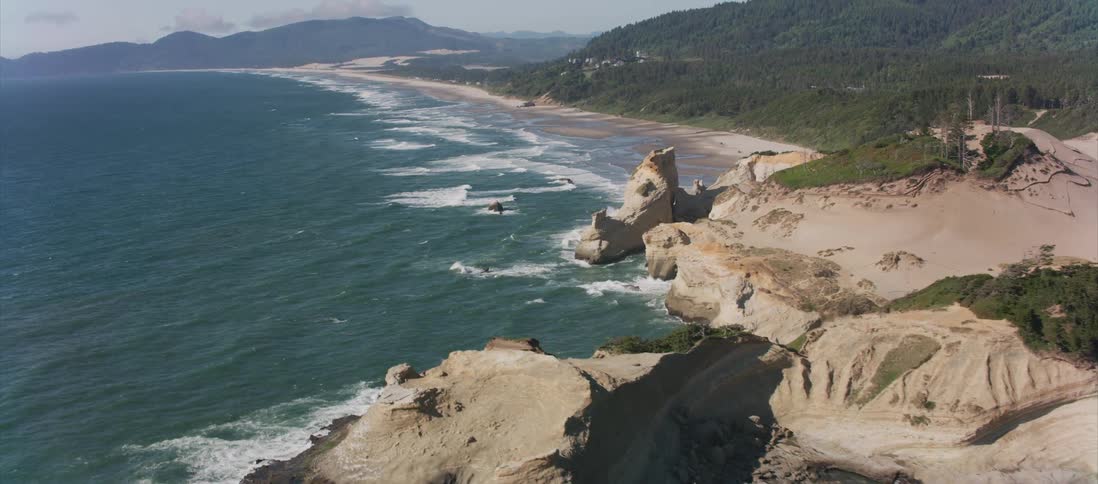 Camera flies over the ocean coast