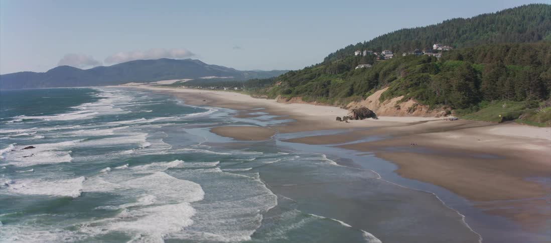 Waves ripple and crash into the beach shoreline