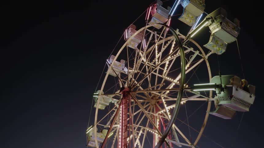 A ferris wheel stops moving with people still on the ride