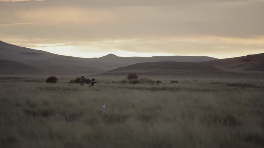 The sun sets over the prairie
