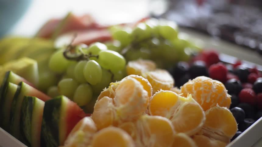 The dish on the table is full of fruit
