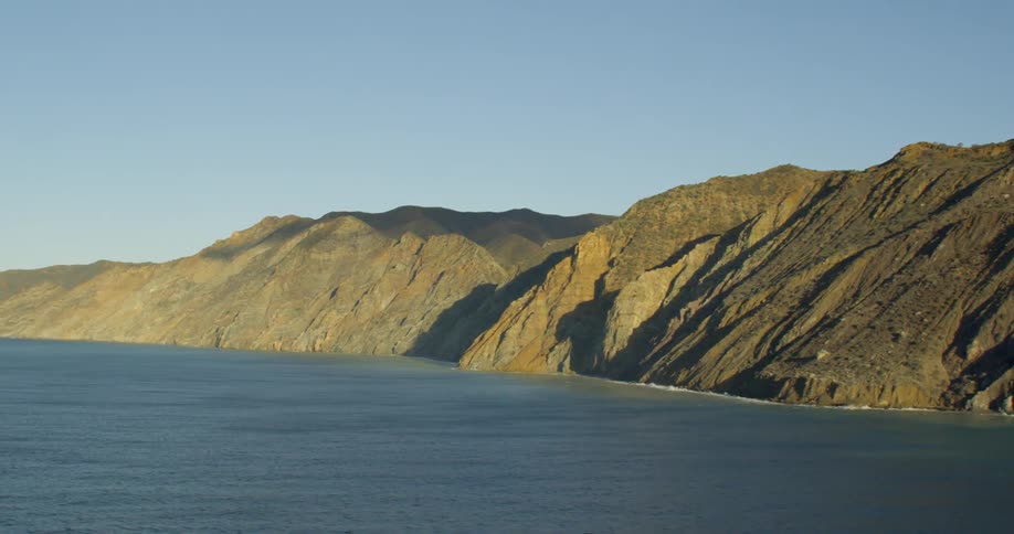 Bordered by a large but calm body of ocean water the coastline is comprised of steeply sloping green mountains