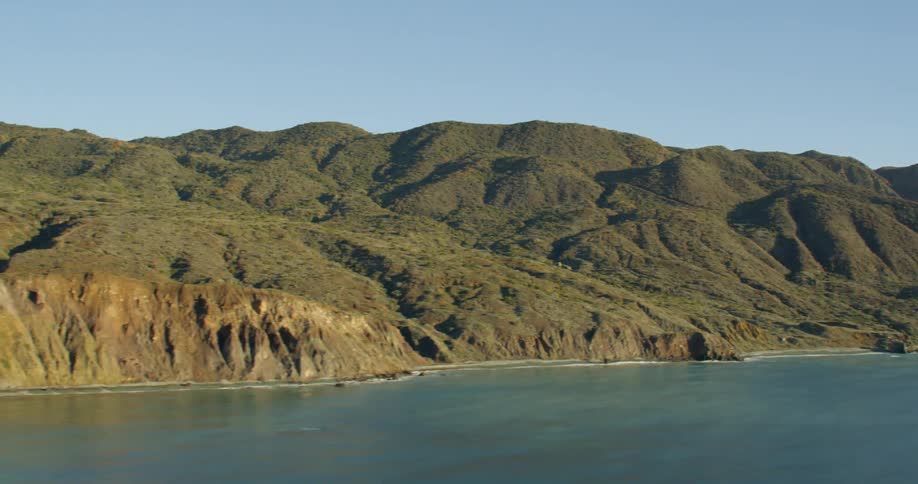 Range of mountains seaside in the daytime
