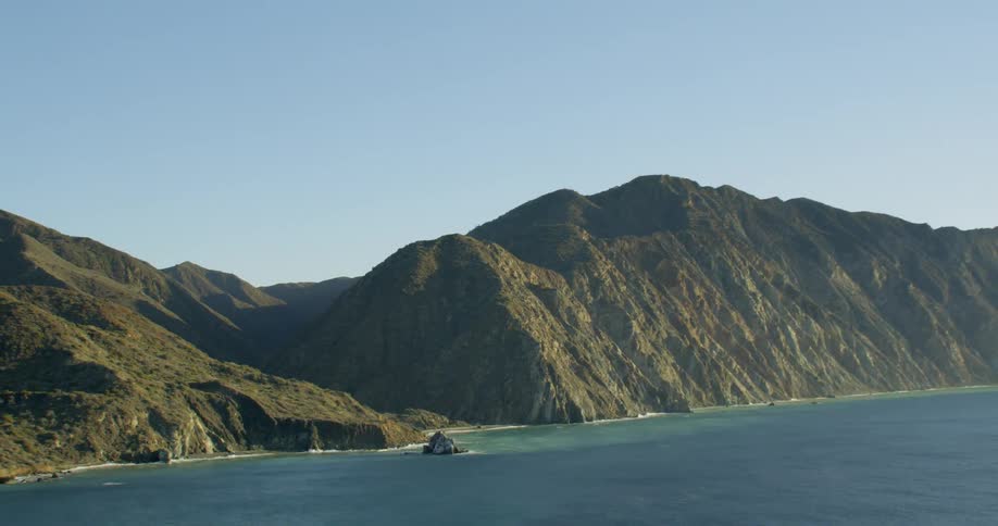An aerial view of a coast with mountains