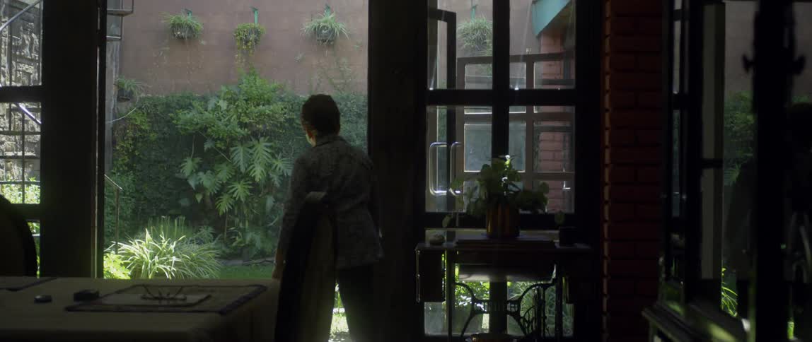 A woman walks out to the garden