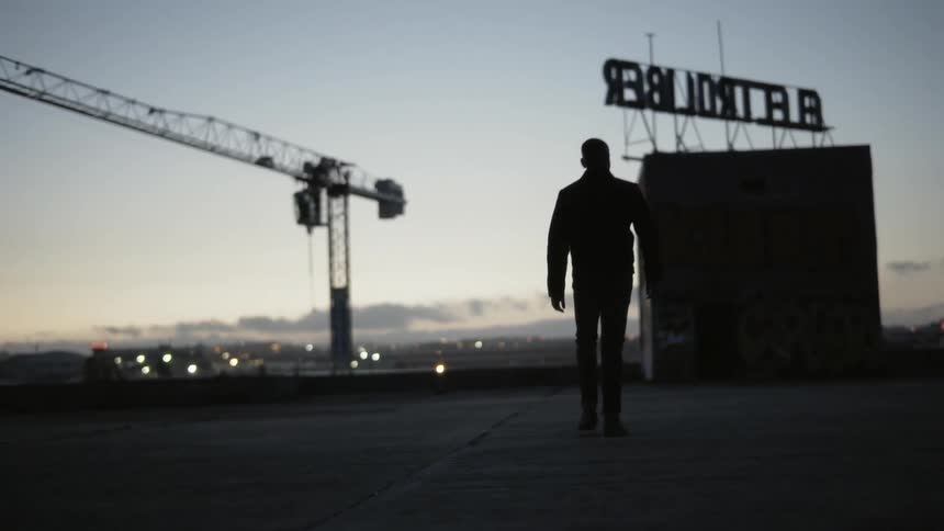 Man walking across a rooftop