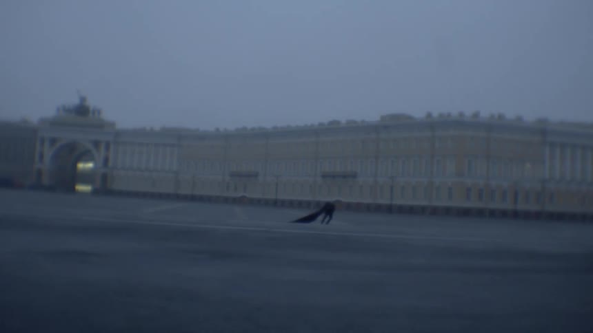 A man walks across a plaza