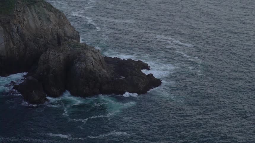 Waves hit the cliff rocks