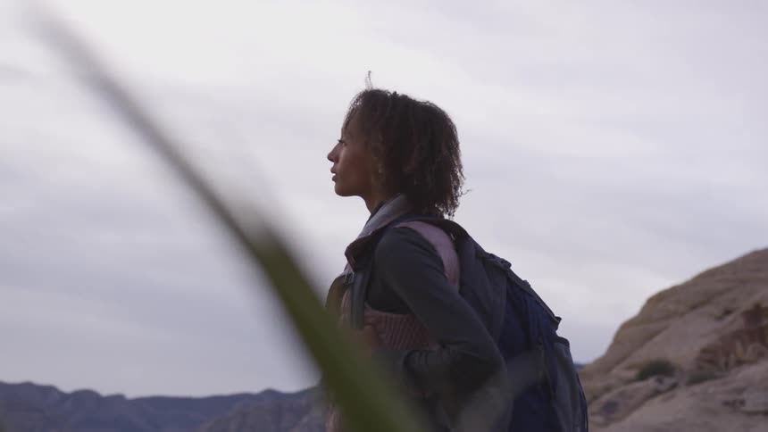 A woman hiking in an arid landscape
