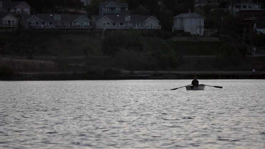 Person paddling a boat down a river