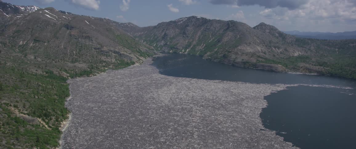Pebbled shore on lake near mountains