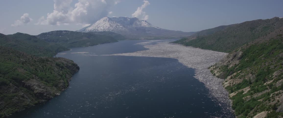A reservoir is located in the valley of forest covered mountains