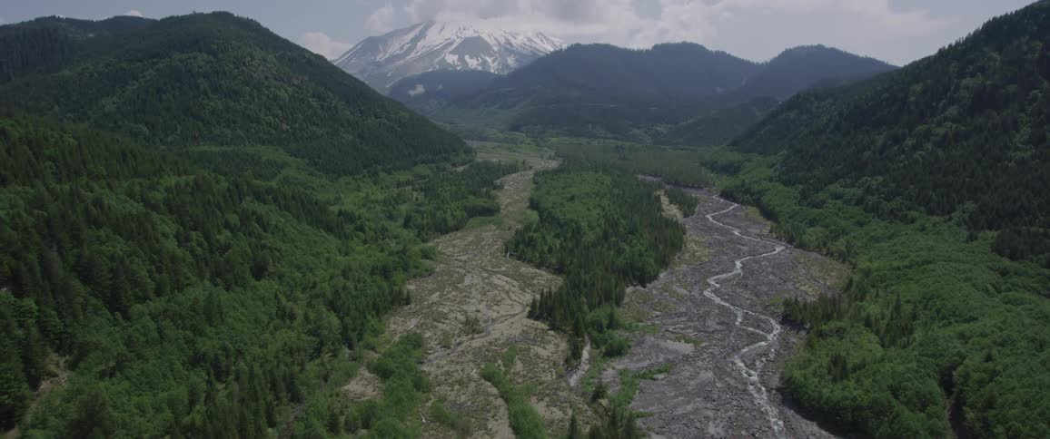 A frozen stream runs along the hills in this beautiful lush green valley