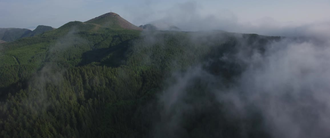 Clouds hover over hilly terrain