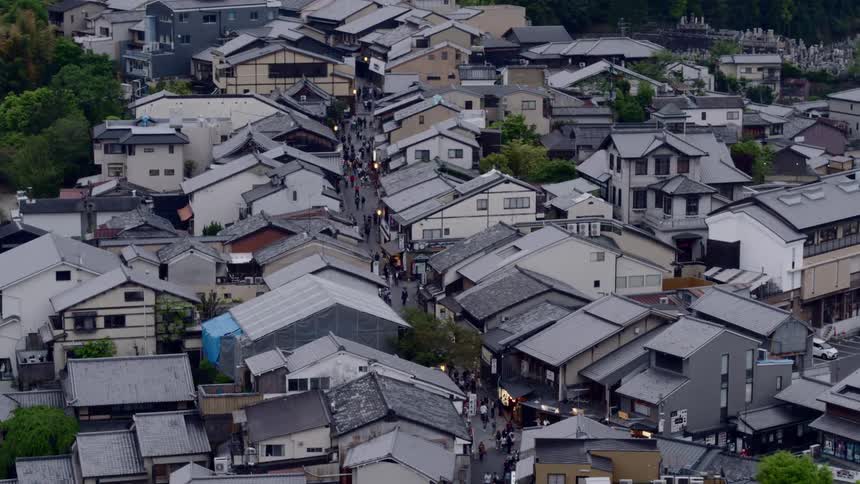 A large number of people walk through neighborhood streets