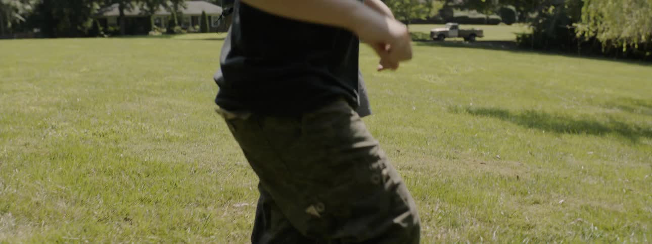 A man dribbles a soccer ball through a grass field