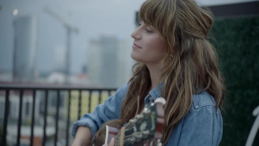 Woman play guitar outside