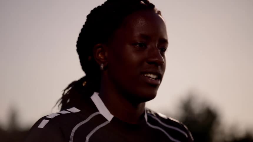 A young black woman runs