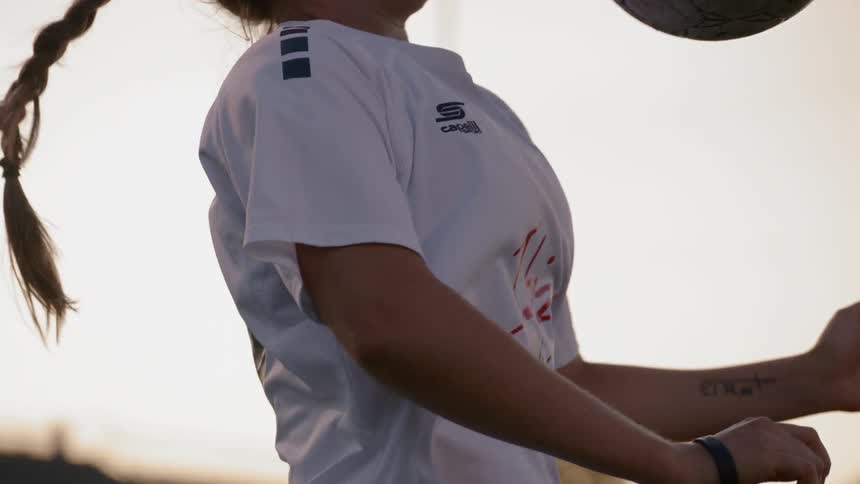 Female soccer player blocking a shot with her chest