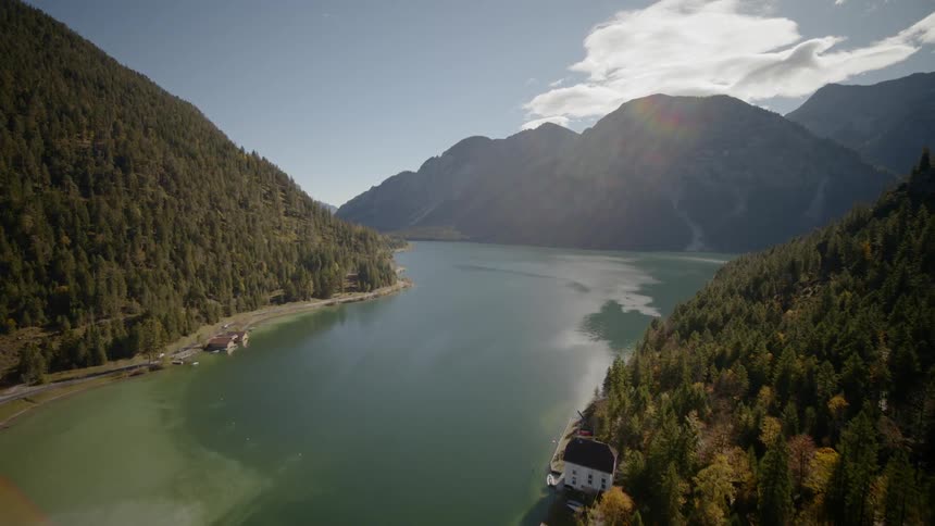 A body of water with forest on both sides