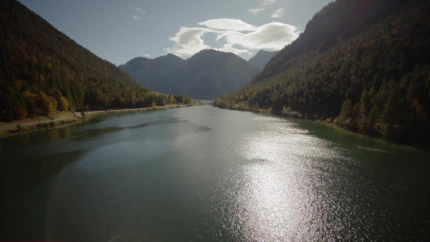 A body of water sits between mountains