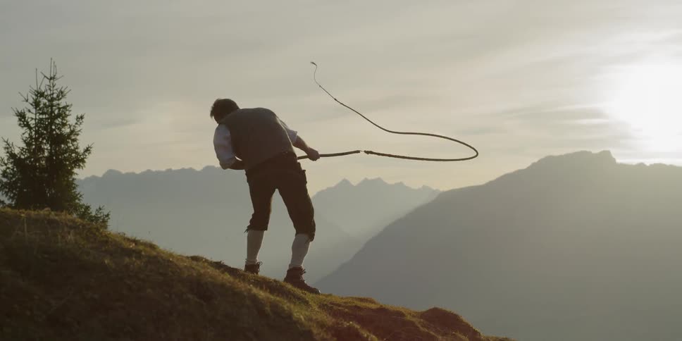 Man cracks whip on slope