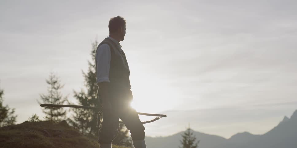 Man stands holding whip