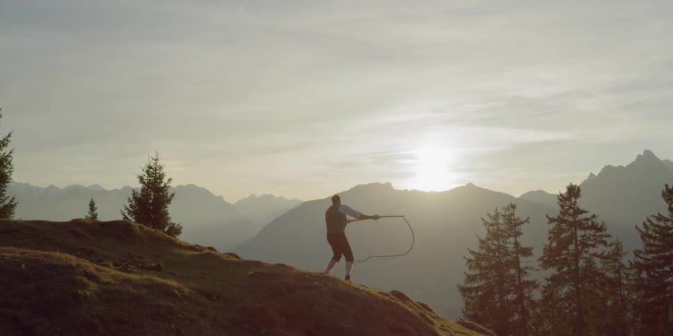 A man practicing throwing a rope
