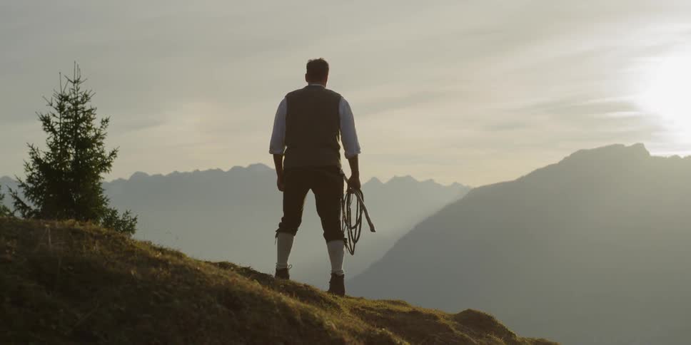 A man is walking up a hill