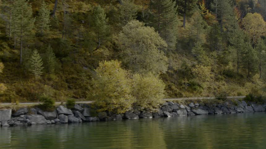 Two cyclists biking along the river