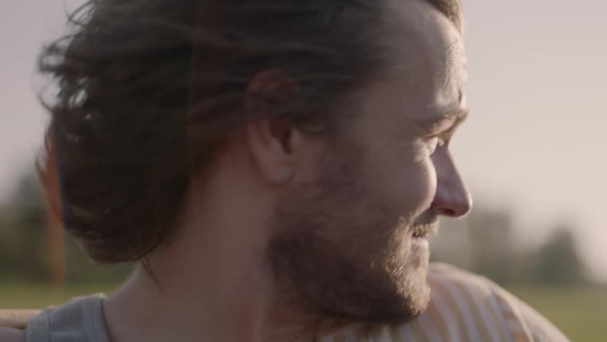 A young man stands in the wind
