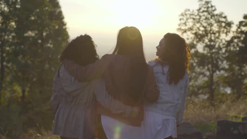 Three friends hugging