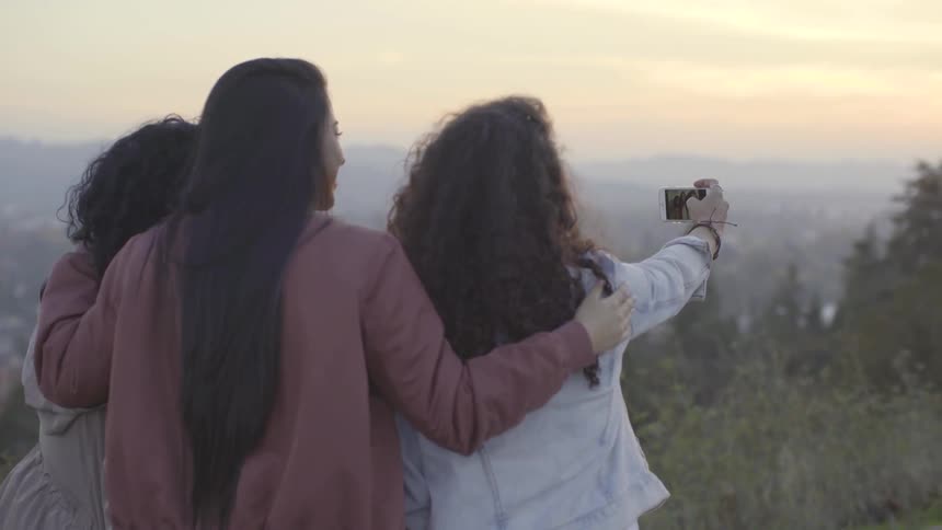 Three women take a selfie together
