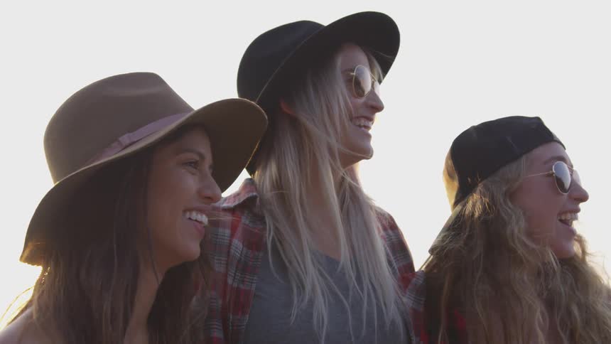 Three women laugh together