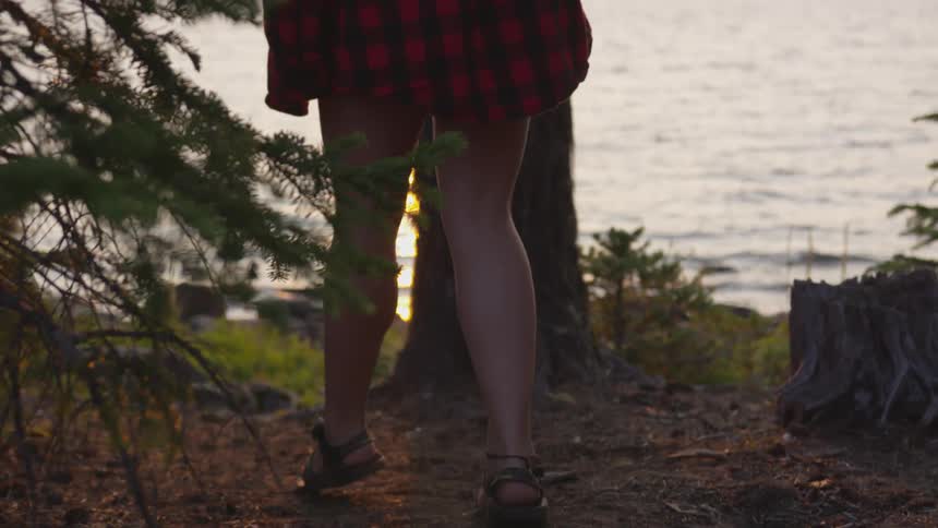 Woman walks down to shore