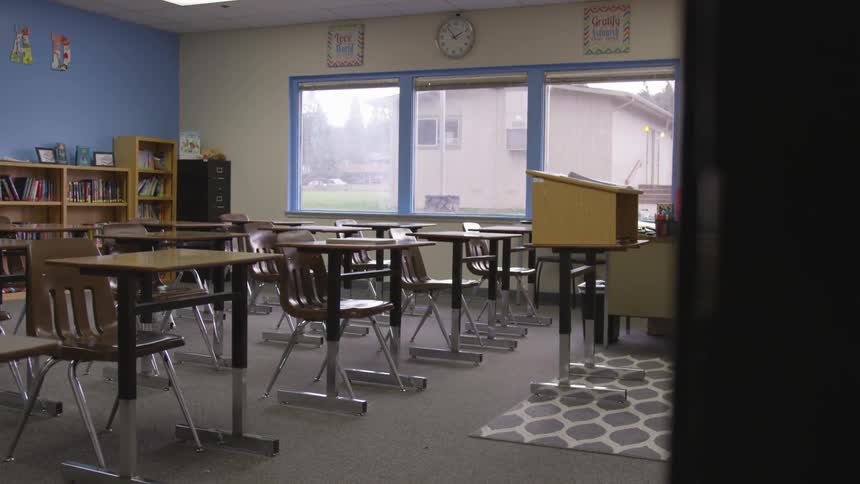Empty school classroom with temporary classroom seen through the window