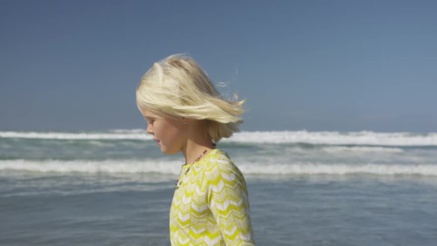 A child walks along the beach
