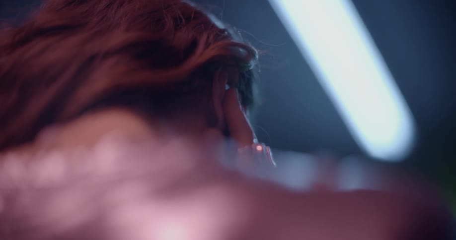 A woman is putting an earpiece in