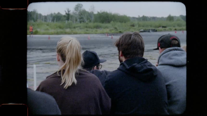 A crowd watching a car race