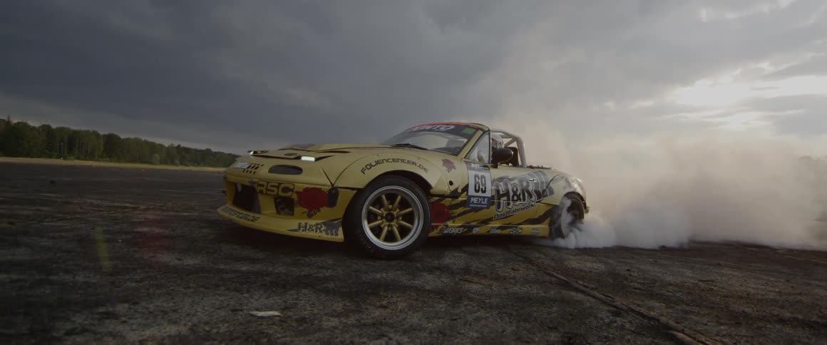 A car does a burnout on asphalt
