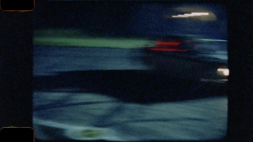 Drivers oversteer while maintaining control and driving the race cars through the entirety of a corner at night