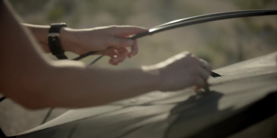 Woman erecting a tent