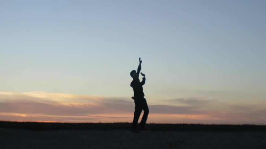 Man dancing at dusk