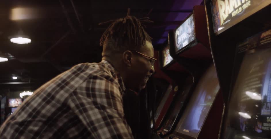 A couple laughs as they play an arcade game together