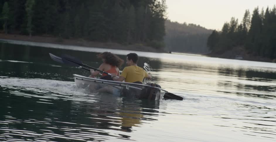 Man and woman sit in rowboat and play