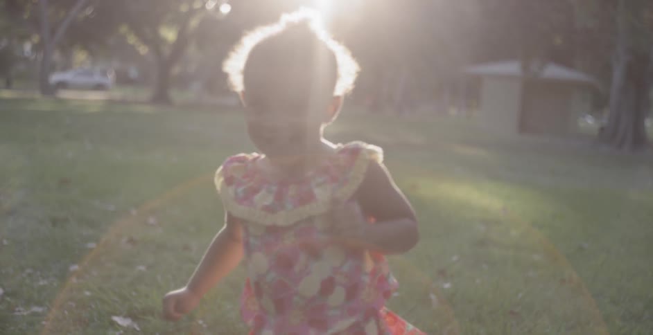 A girl in the park running and smiling