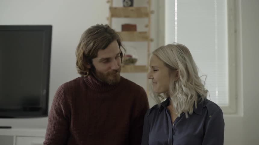 Couple smile and cuddle