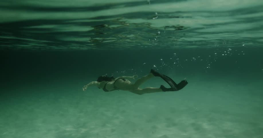 A woman swims underwater