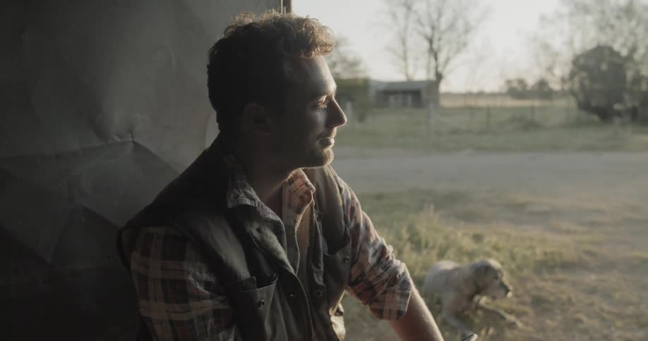 A man in the countryside looking at his phone