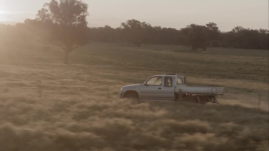 A truck drives along a county road